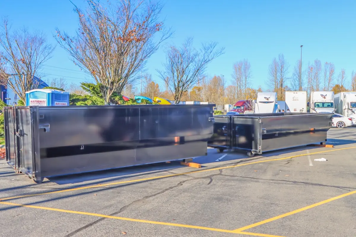 Professional dumpster rental service with roll-off container on residential driveway in Corbin